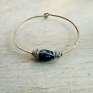 Handcrafted Gold-Tone Bangle with Dark Stone Accent